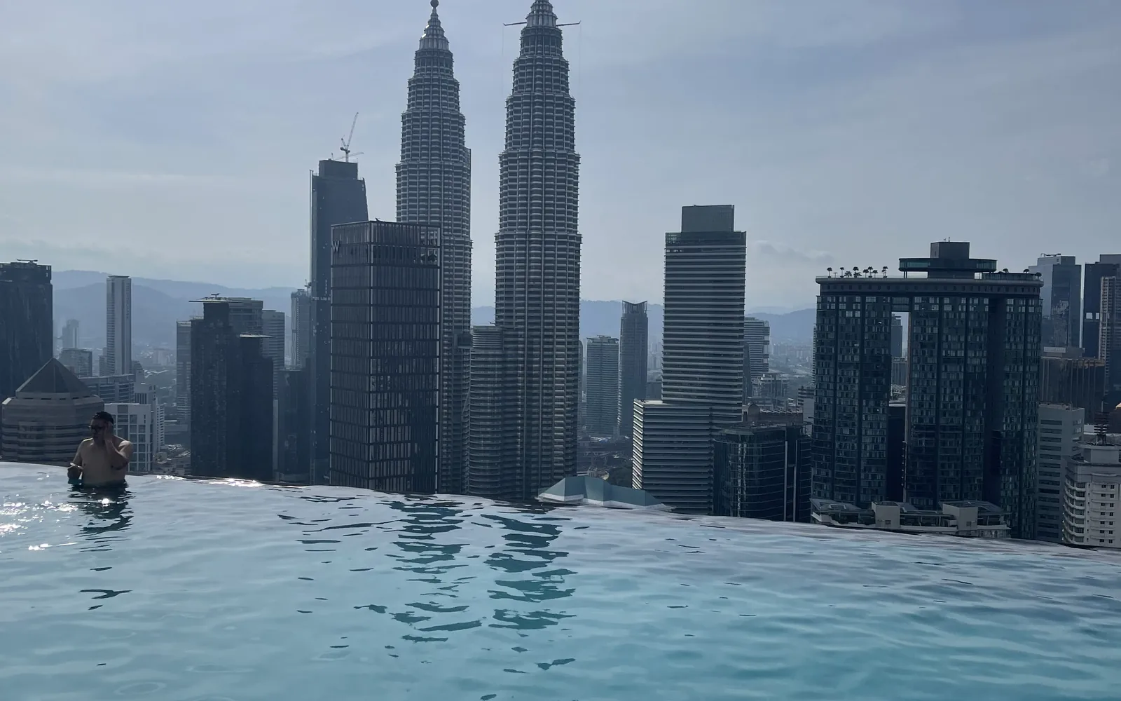 The Petronas Towers and KL skyline from a rooftop pool, Malaysia — photo by goFLY founder Mahabub Alam Razu
