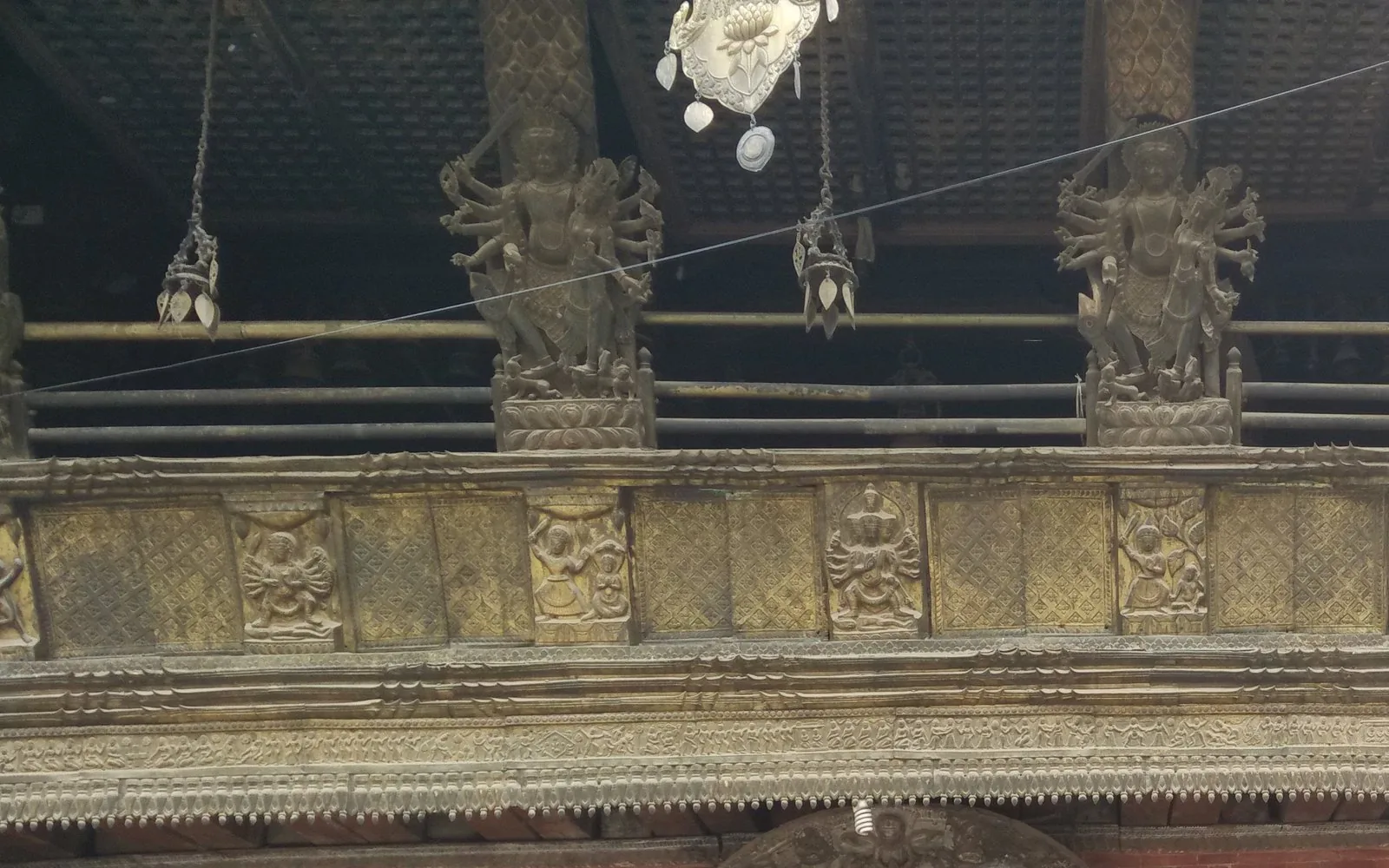 Intricately carved Newari temple facade with gilded deity figures in the Kathmandu Valley — photo by goFLY founder Mahabub Alam Razu, May 2017