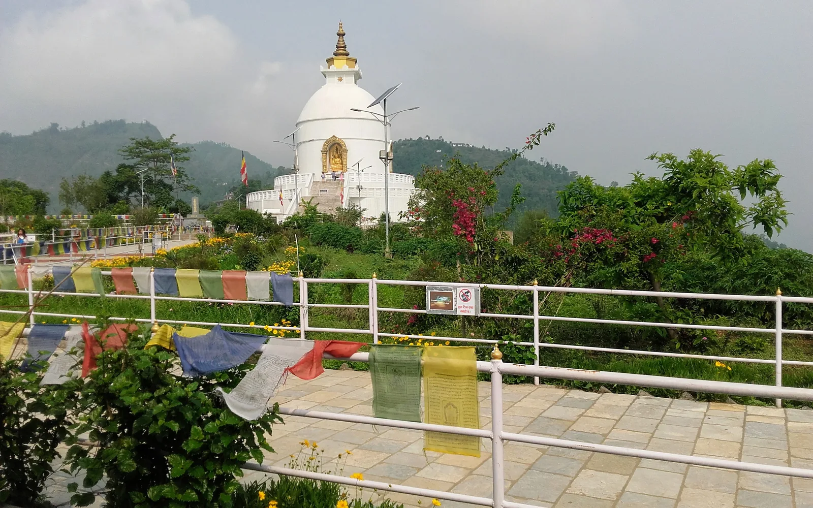 Prayer flags and flowers at the World Peace Pagoda above Pokhara — photo by goFLY founder Mahabub Alam Razu, May 2017