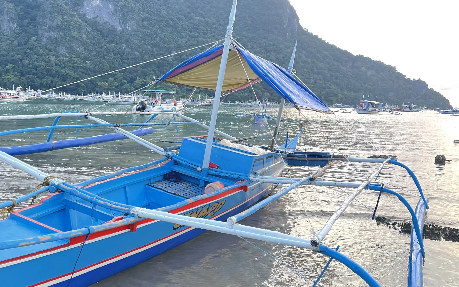Colourful bangka outrigger boats lined up on an El Nido beach, Palawan, Philippines — photo by goFLY founder Mahabub Alam Razu, August 2024