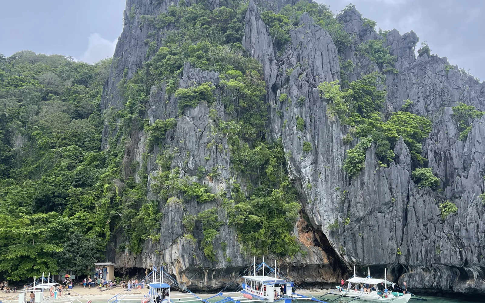 Outrigger boats on a karst-backed El Nido beach, Palawan, Philippines — photo by goFLY founder Mahabub Alam Razu