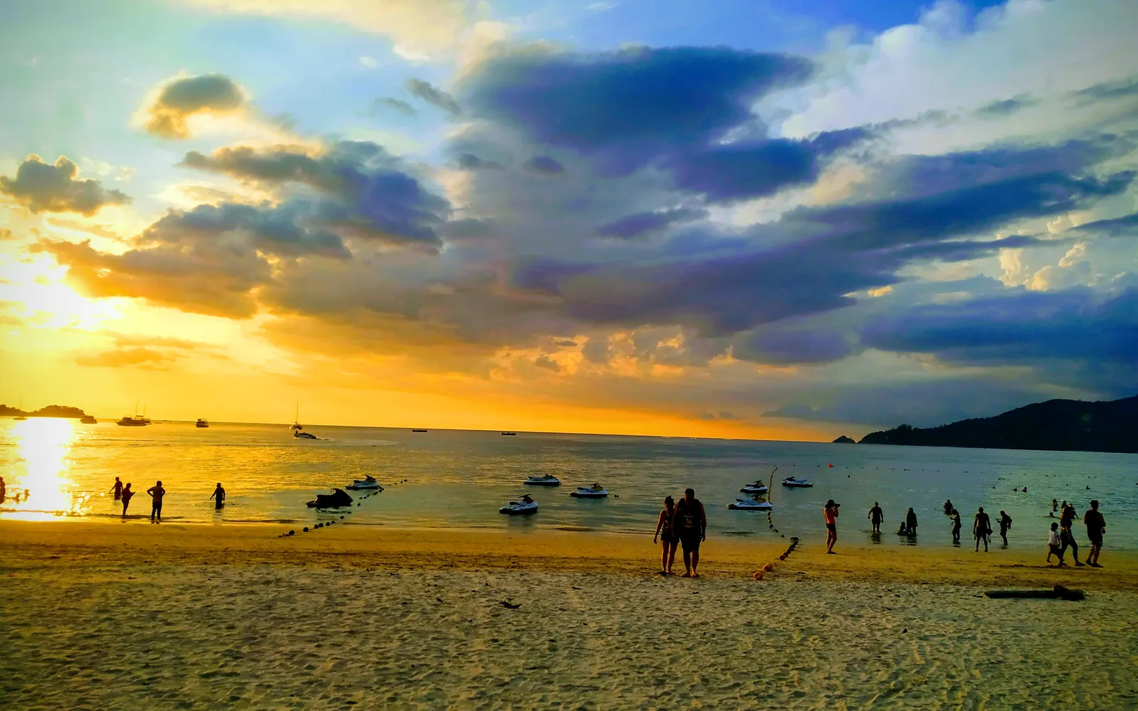 Golden sunset over Patong Beach with longtail boats on the water, Phuket, Thailand — photo by goFLY founder Mahabub Alam Razu, March 2019