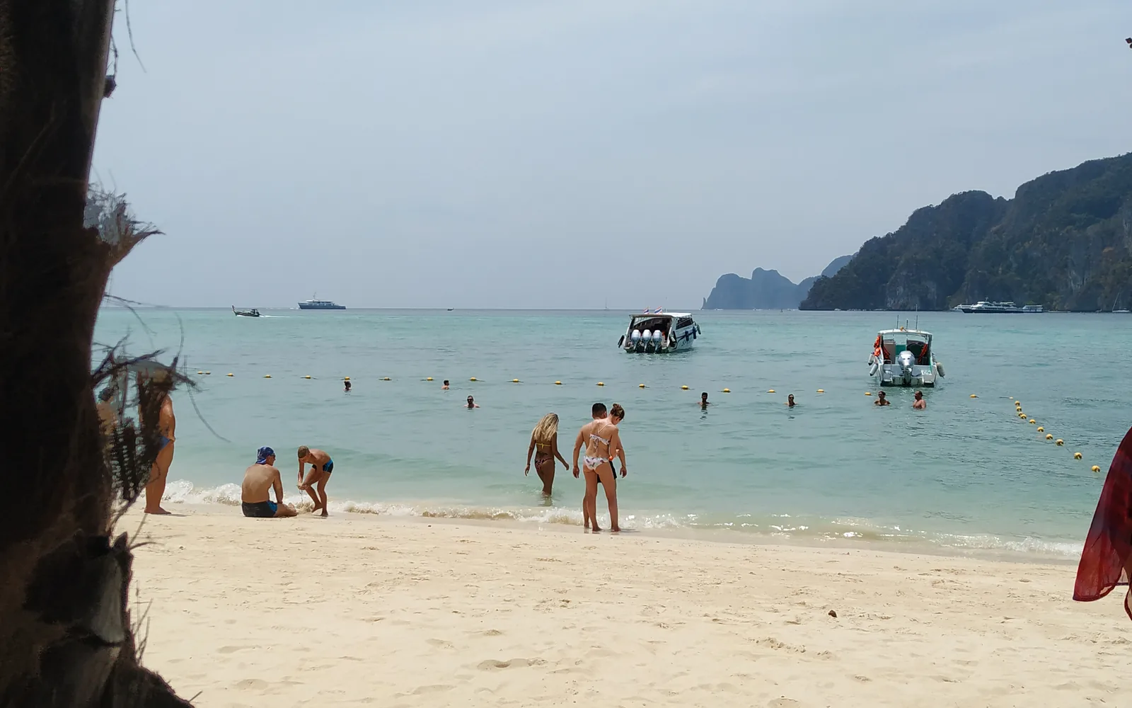 A palm-fringed Phi Phi island beach with longtail boats and turquoise sea, Thailand — photo by goFLY founder Mahabub Alam Razu, March 2019